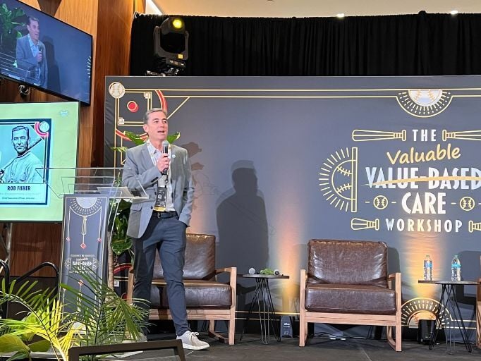 A person is giving a speech on stage at a conference