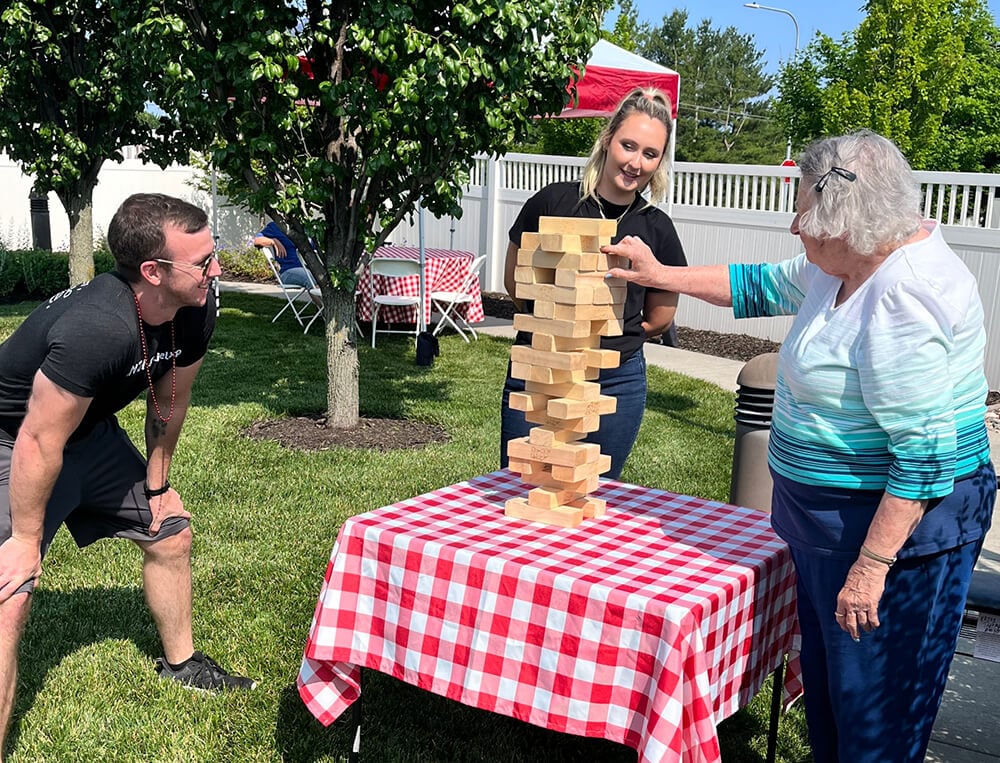 A woman tries her hand at Jumbo Jenga