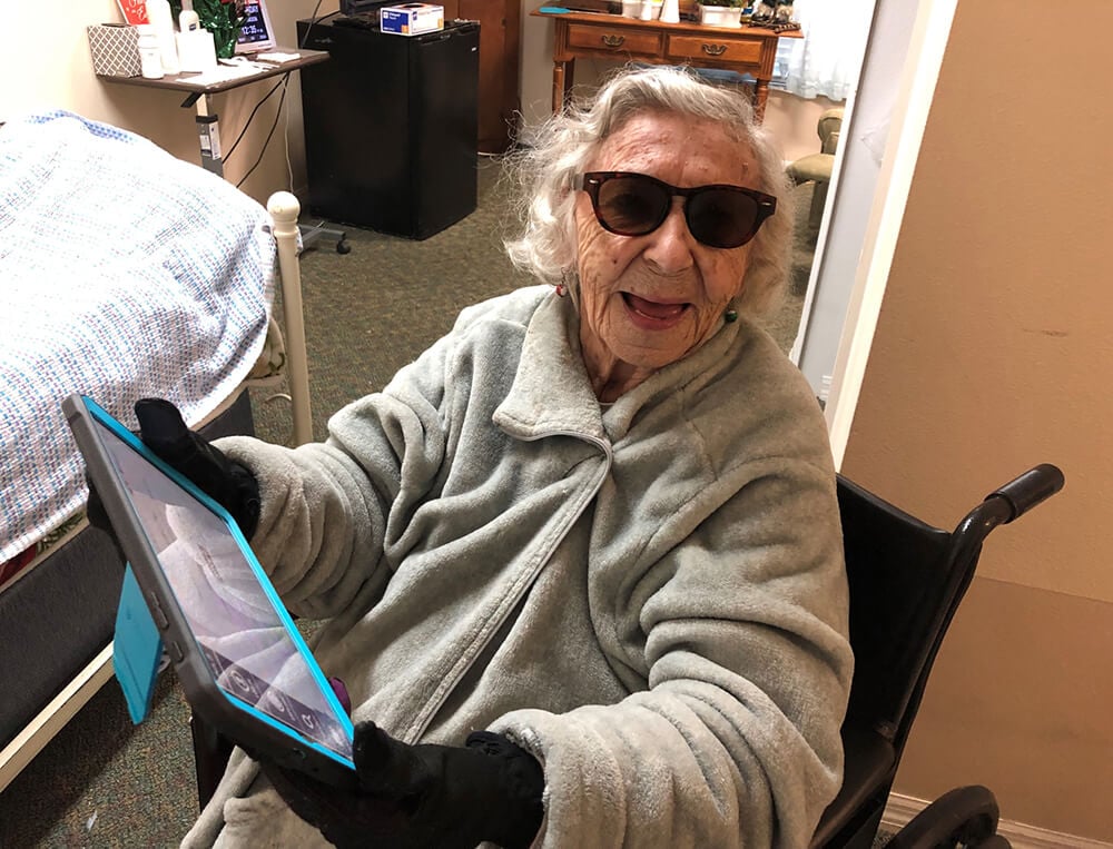 An older woman wearing sunglasses indoors