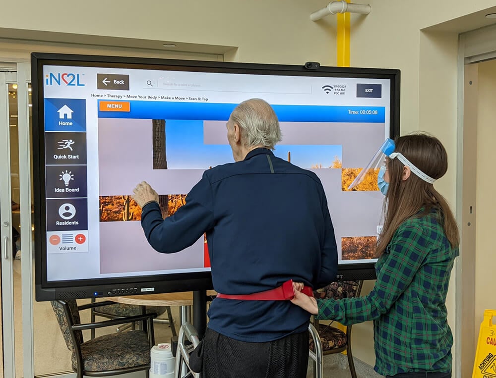 An elderly resident enjoys a game with LifeLoop