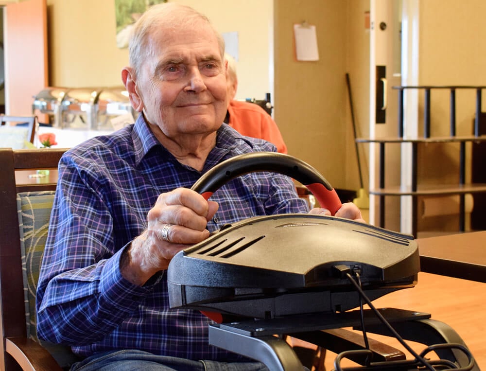 A smiling man on a mobility scooter