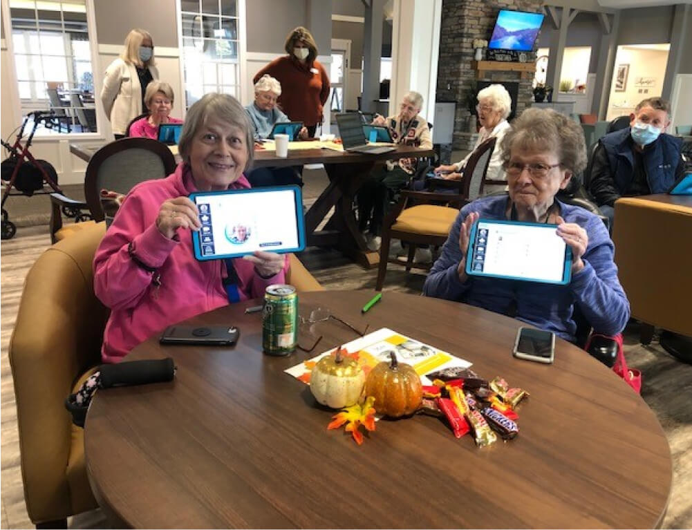 A group of residents show off their LifeLoop tablets